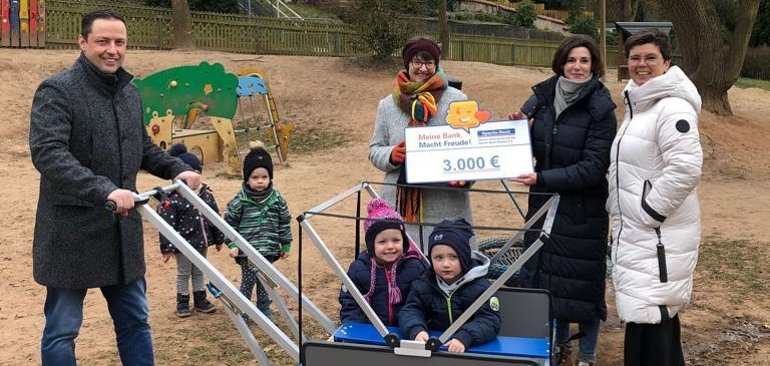 Übergabe des Kinderwagens mit Vertretern der Sparda-Bank Hessen, der KiTa und der Gemeinde