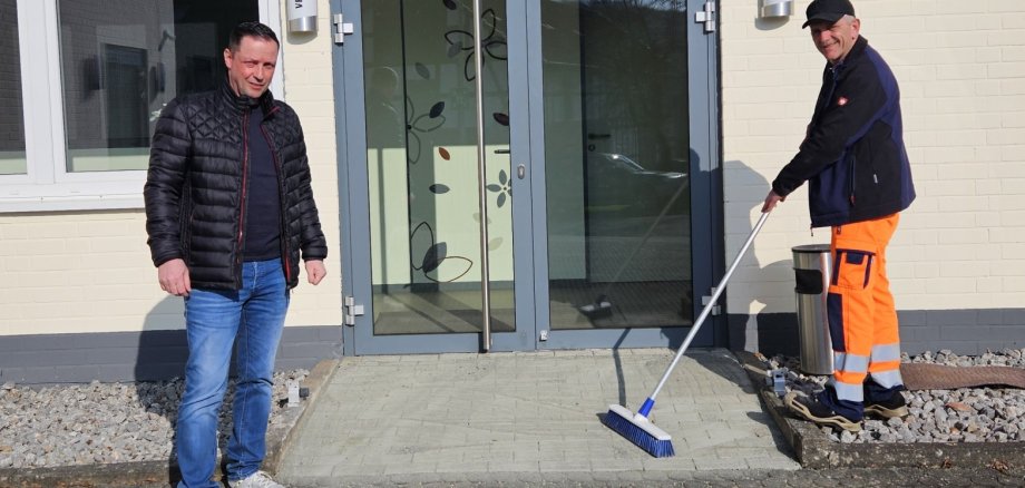 Bürgermeister Holger Siemon und Leiterin des Bürgerbüros Verena Schneider vor der neuen Trennwand